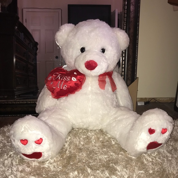 big white teddy bear with red bow